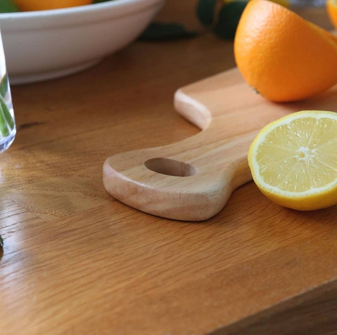 Wooden cutting board with handle