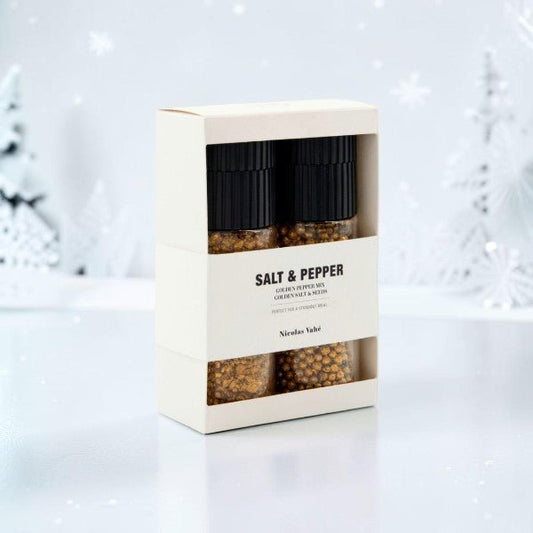 Golden salt and pepper mixture in a ceramic grinder